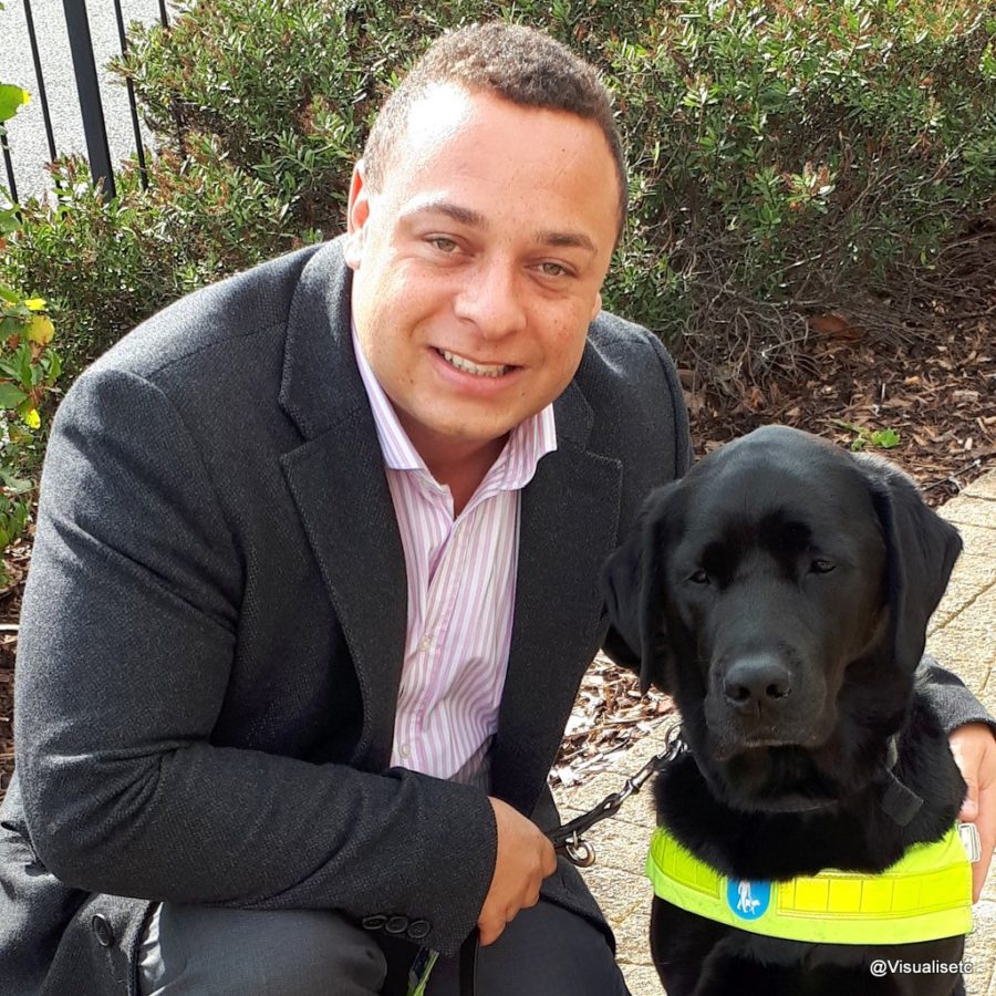 Dan with his arm around his trusty guide dog Zodiac