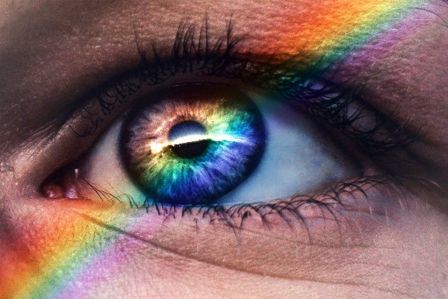 Close up image of an eye with rainbow lights running through it
