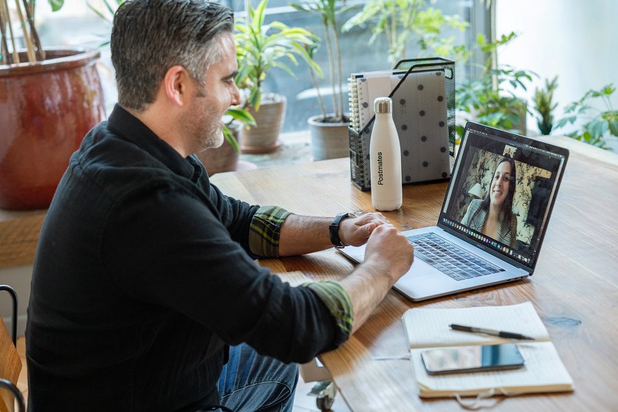 An image showing two people communicating via a video call. One has hearing loss.